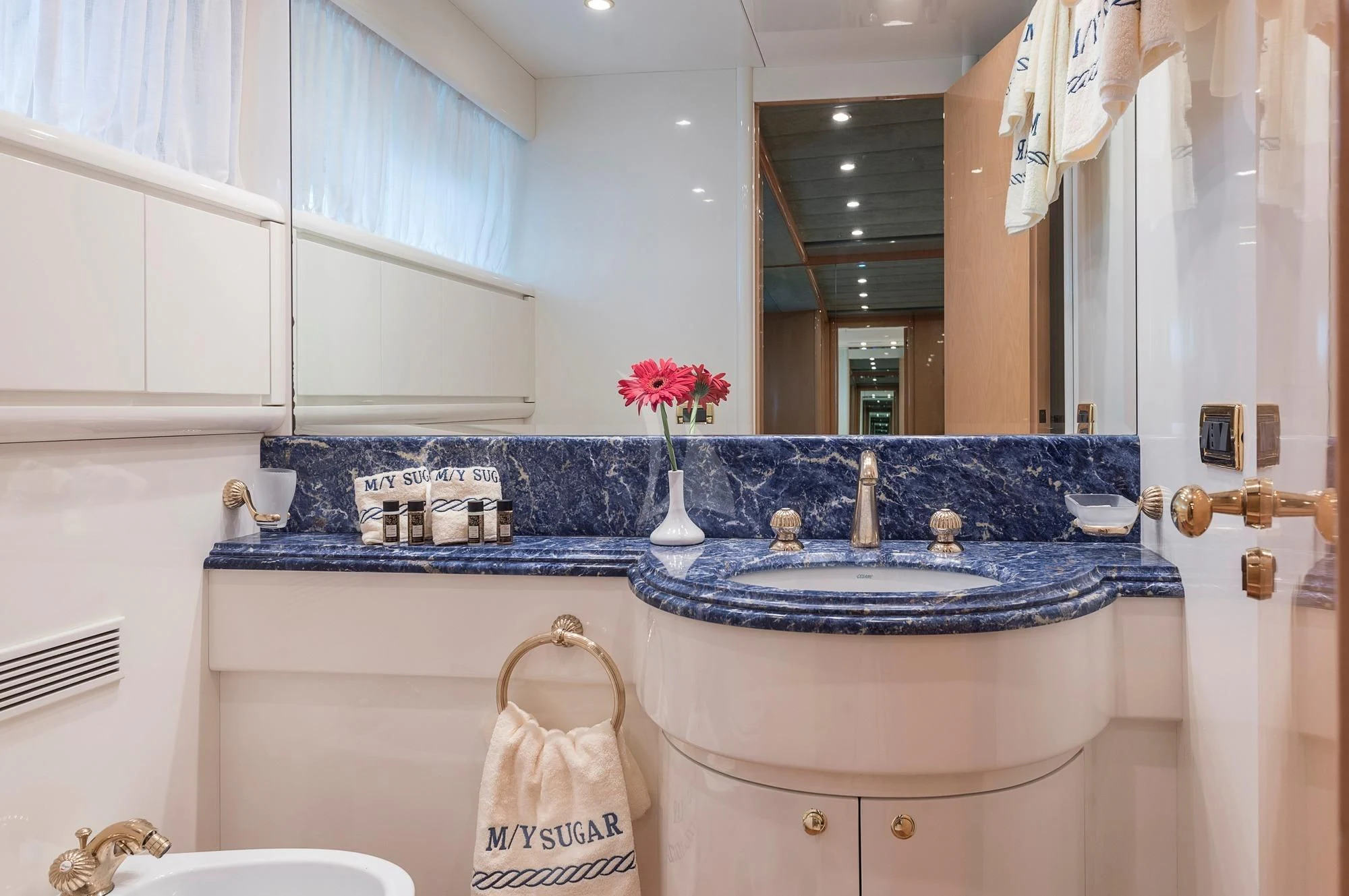 a bathroom with a sink and a mirror aboard SUGAR Yacht for Sale