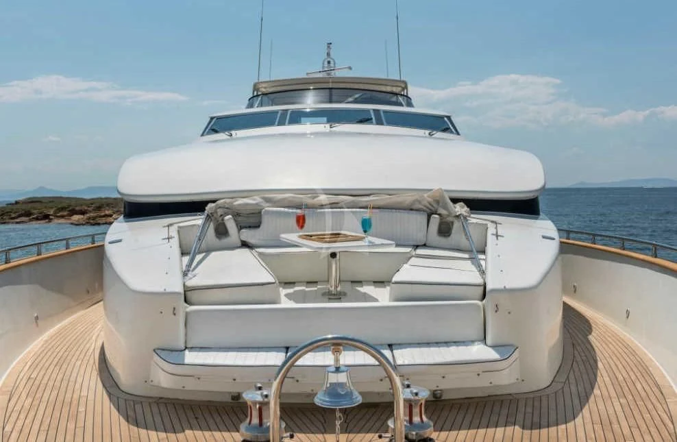 a white boat on a dock with Camera Obscura in the background aboard SUGAR Yacht for Sale