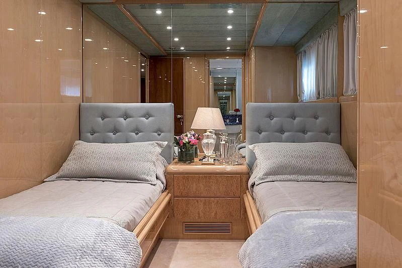 a room with a bed and a mirror aboard SUGAR Yacht for Sale