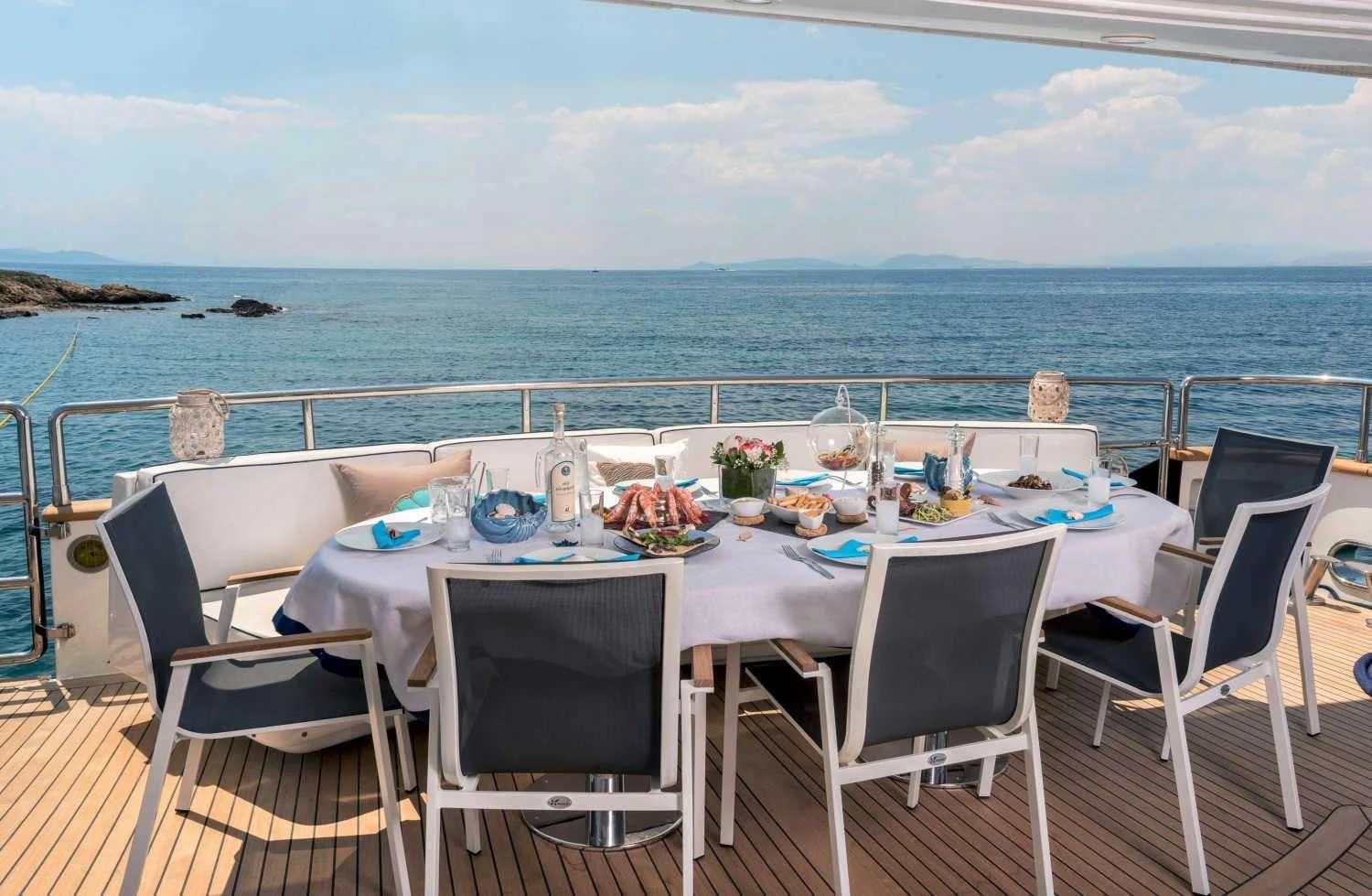 a table set for a meal on a beach aboard SUGAR Yacht for Sale