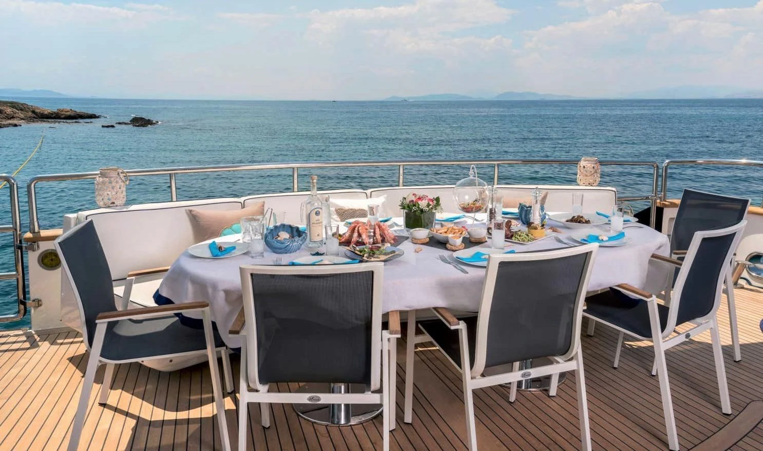 a table set for a meal on a beach aboard SUGAR Yacht for Sale