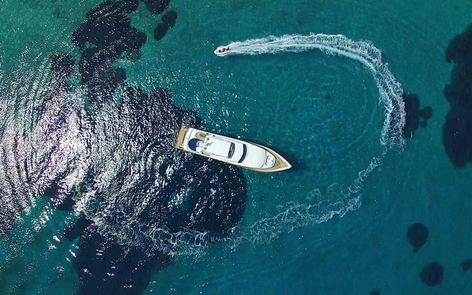 a white and black boat in the water aboard SUGAR Yacht for Sale