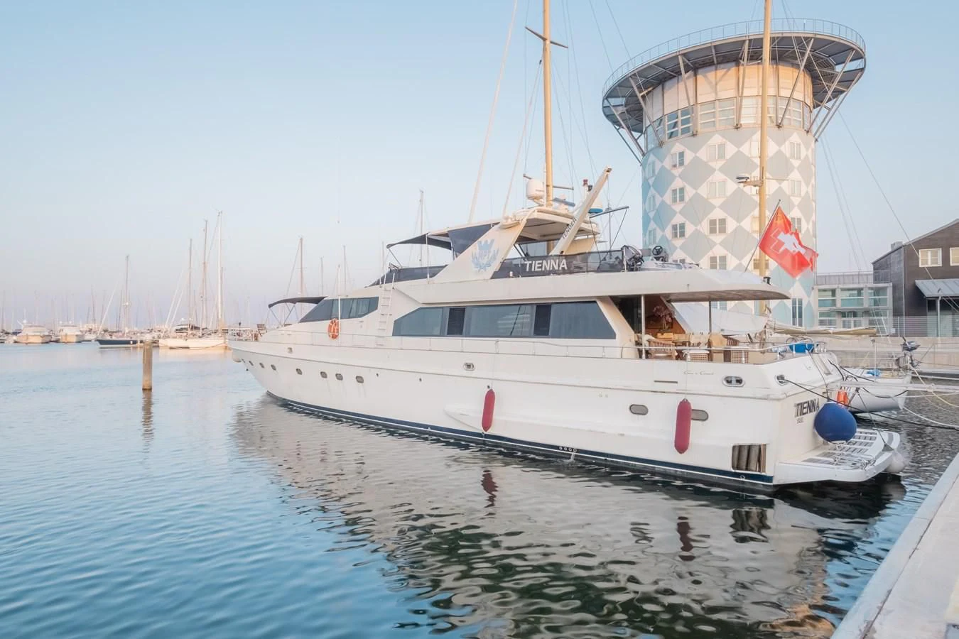 a large white boat in the water aboard TIENNA Yacht for Sale