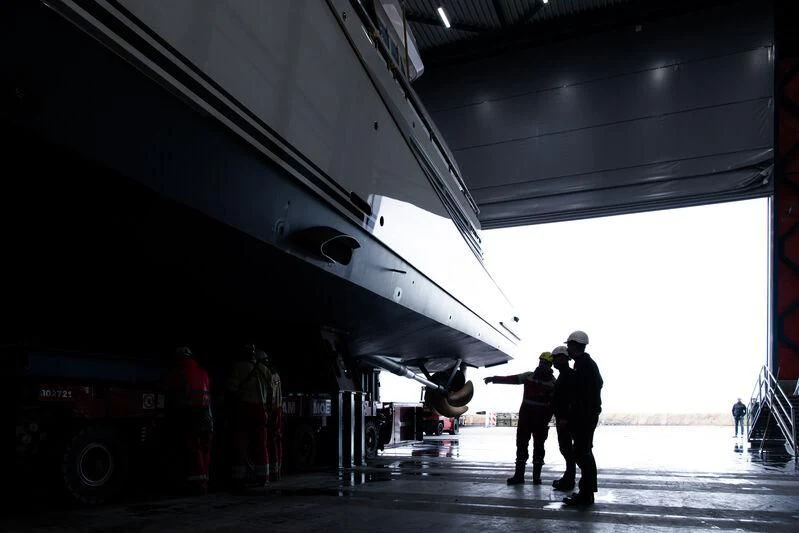 a group of men standing under a train aboard SPECIAL ONE Yacht for Sale
