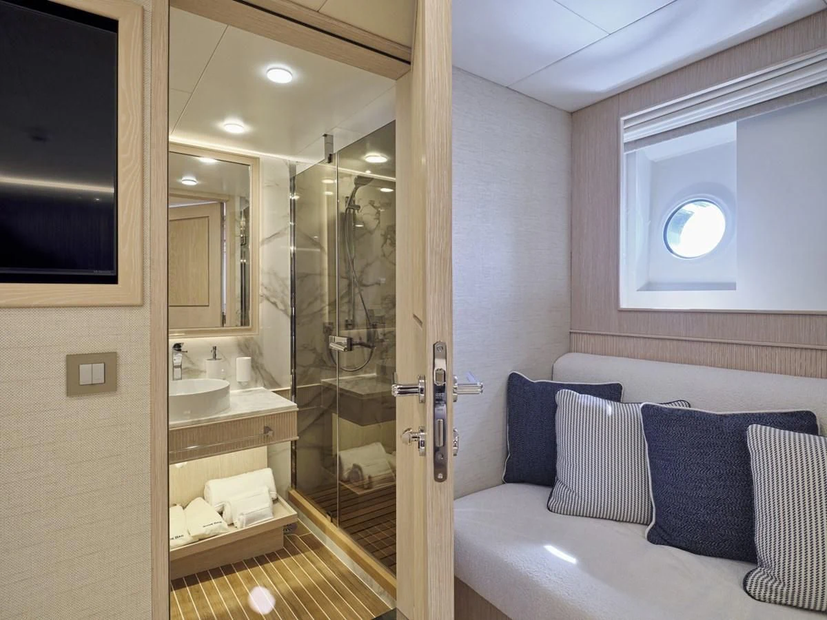 a bathroom with a glass shower aboard OMNIA Yacht for Sale