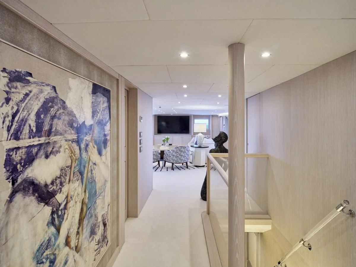 a hallway with a painting on the wall aboard OMNIA Yacht for Sale
