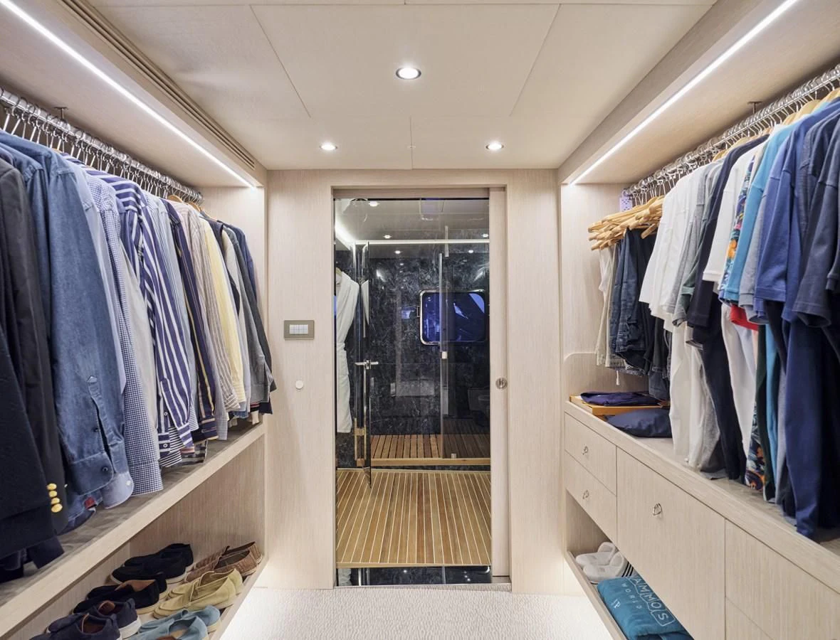a closet full of clothes aboard OMNIA Yacht for Sale