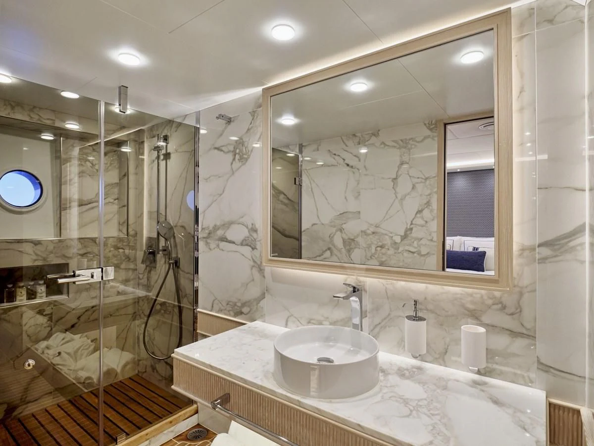 a bathroom with a glass shower aboard OMNIA Yacht for Sale
