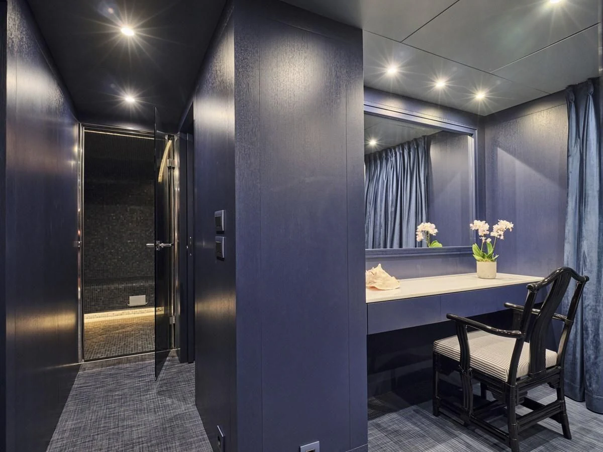 a room with a table and chairs aboard OMNIA Yacht for Sale
