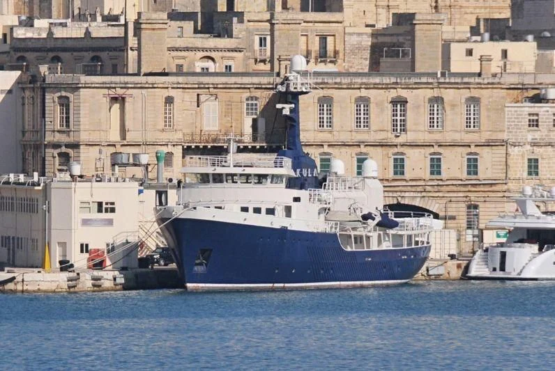 a large boat in the water aboard OMNIA Yacht for Sale