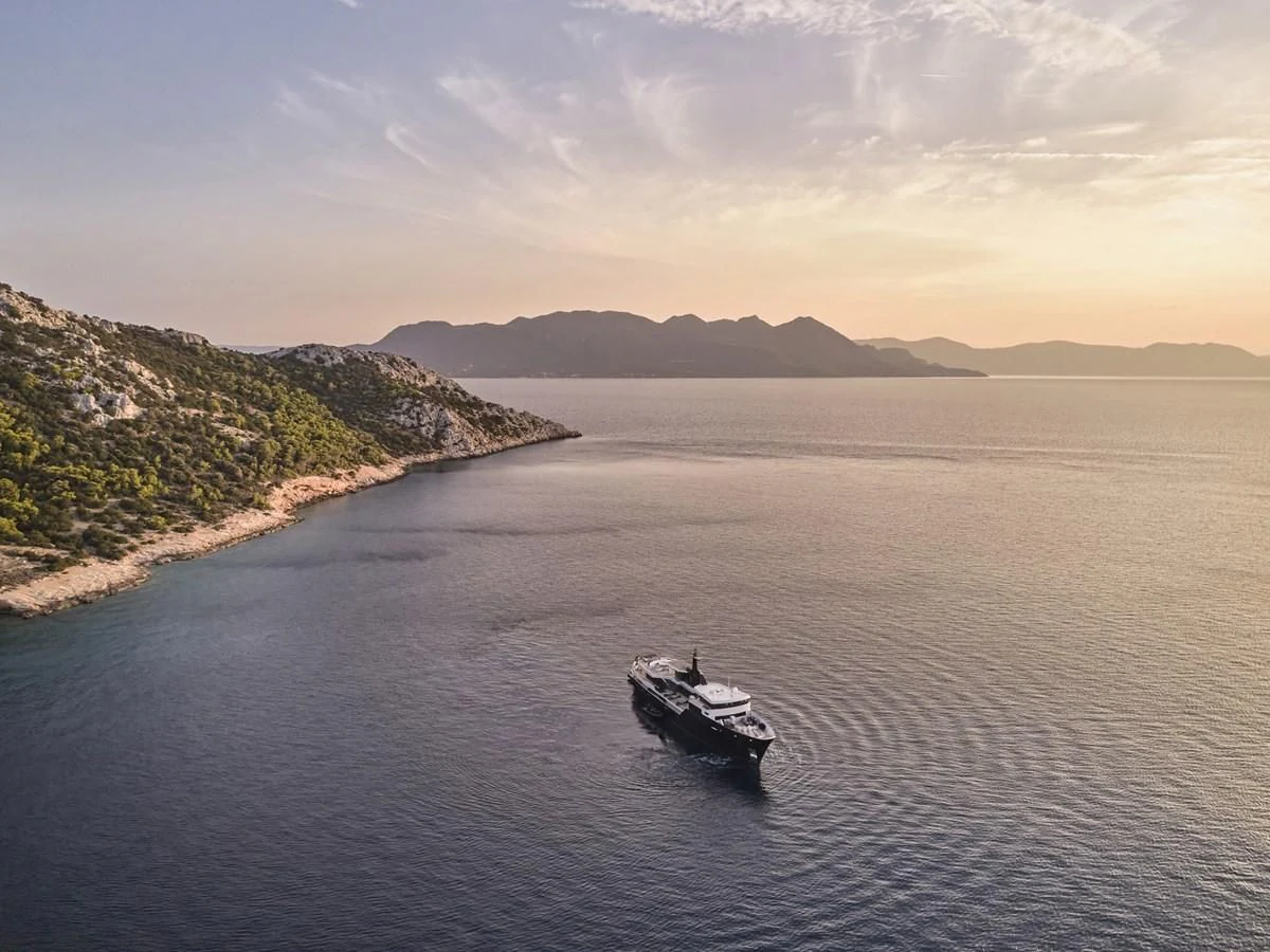 a boat sailing on the water aboard OMNIA Yacht for Sale