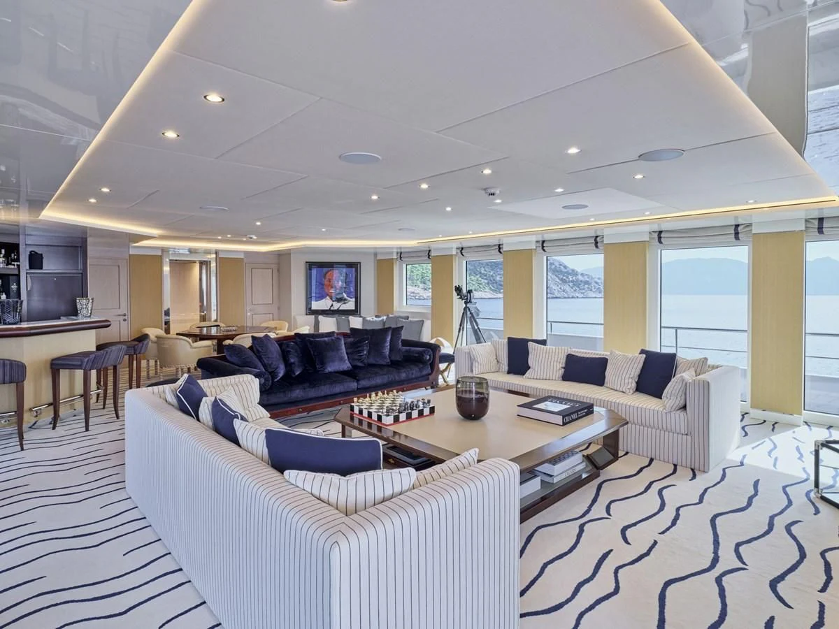 a large living room with a large window aboard OMNIA Yacht for Sale