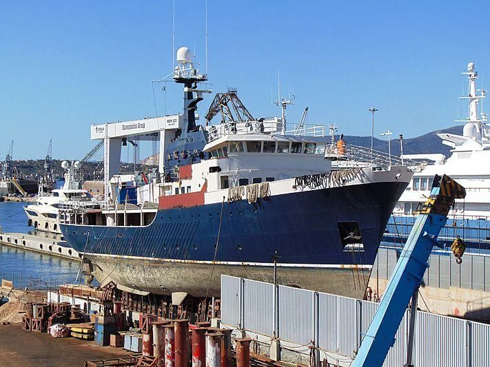 a large ship docked aboard OMNIA Yacht for Sale