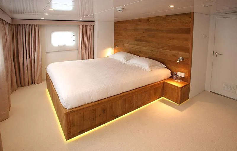 a bed in a room aboard OMNIA Yacht for Sale