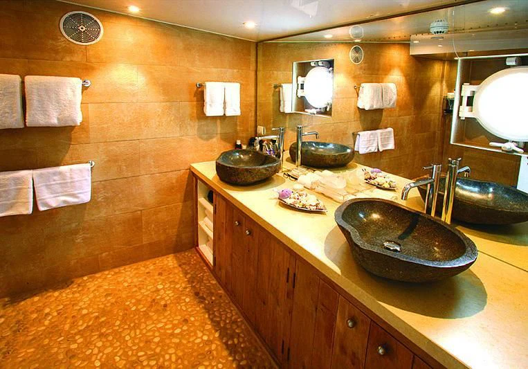 a bathroom with a marble countertop aboard OMNIA Yacht for Sale