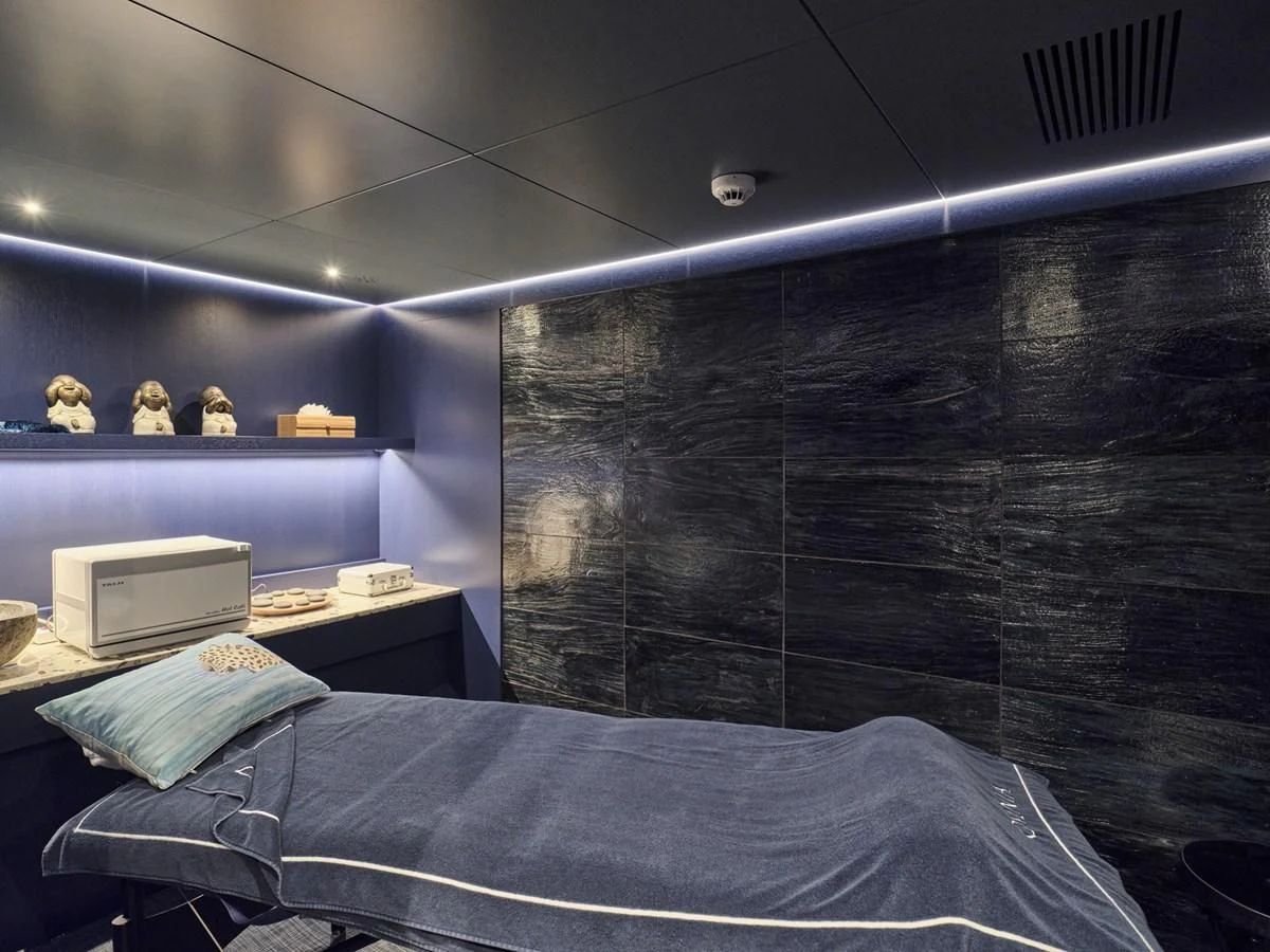 a bed in a room aboard OMNIA Yacht for Sale