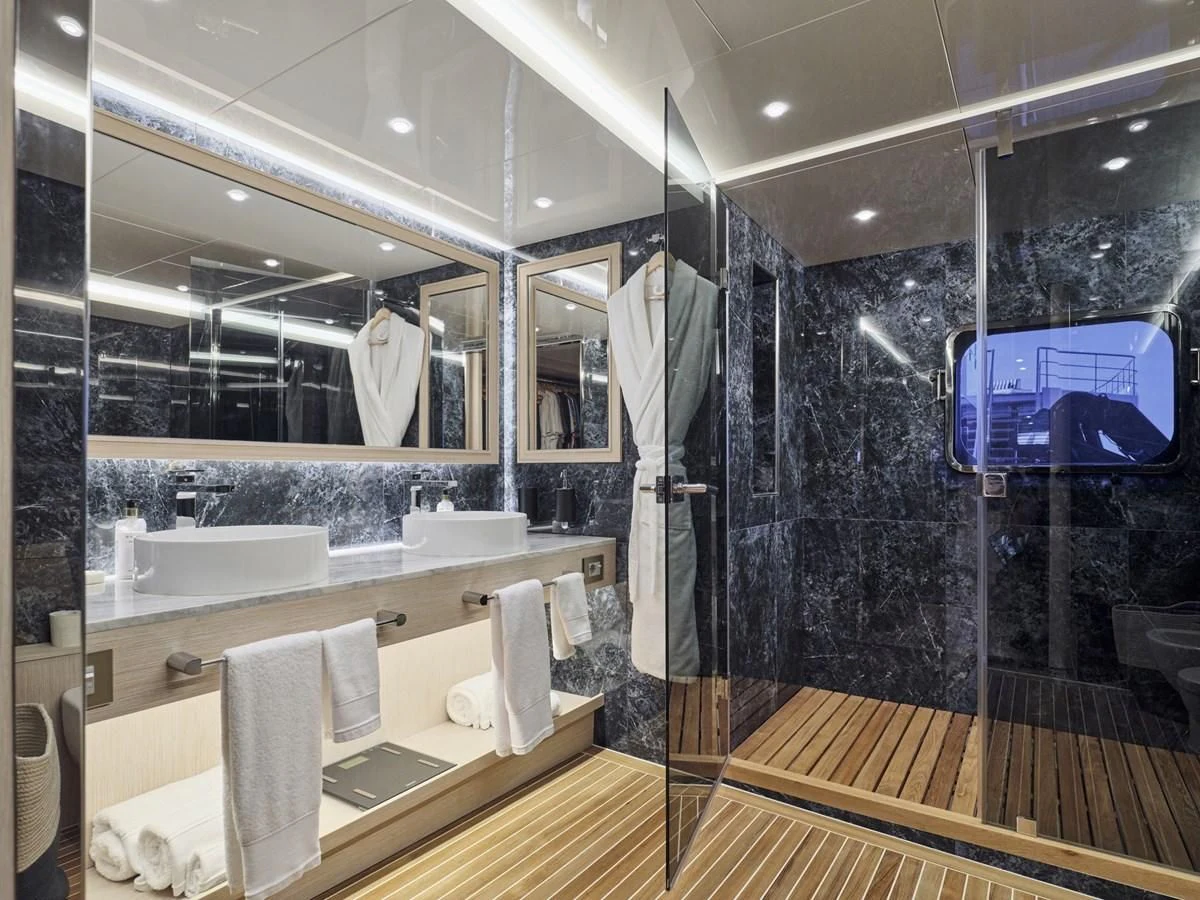 a bathroom with a large mirror aboard OMNIA Yacht for Sale