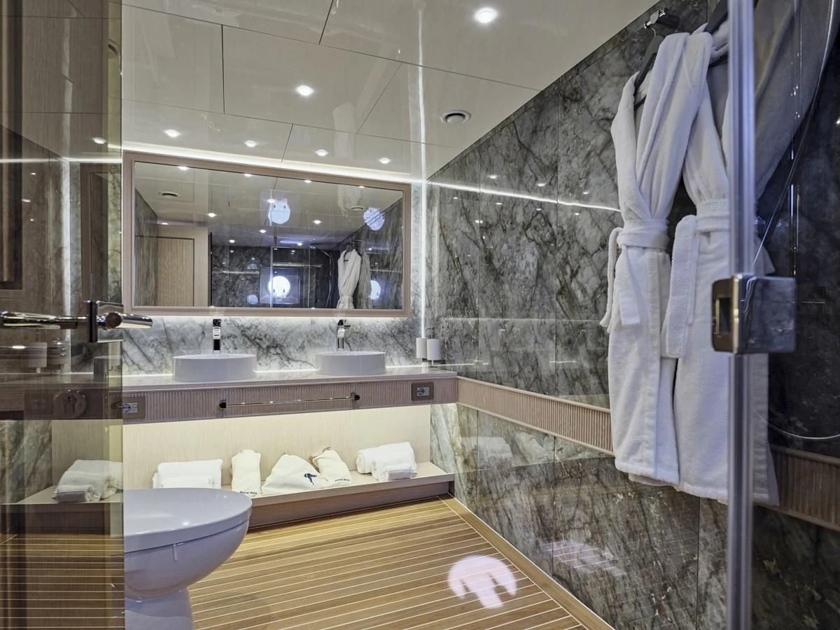 a bathroom with a large mirror aboard OMNIA Yacht for Sale