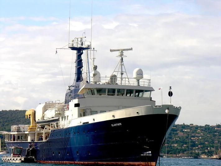 a large ship in the water aboard OMNIA Yacht for Sale