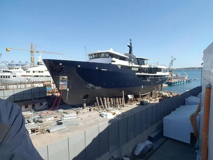 a large ship docked aboard OMNIA Yacht for Sale
