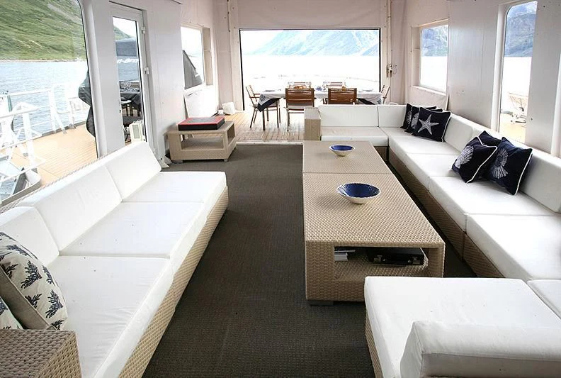 a living room with a large window aboard OMNIA Yacht for Sale
