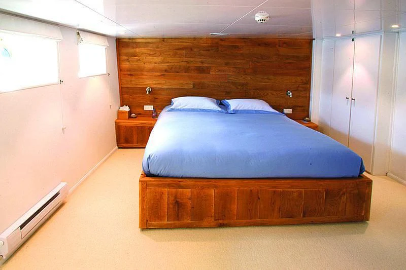 a bed in a room aboard OMNIA Yacht for Sale