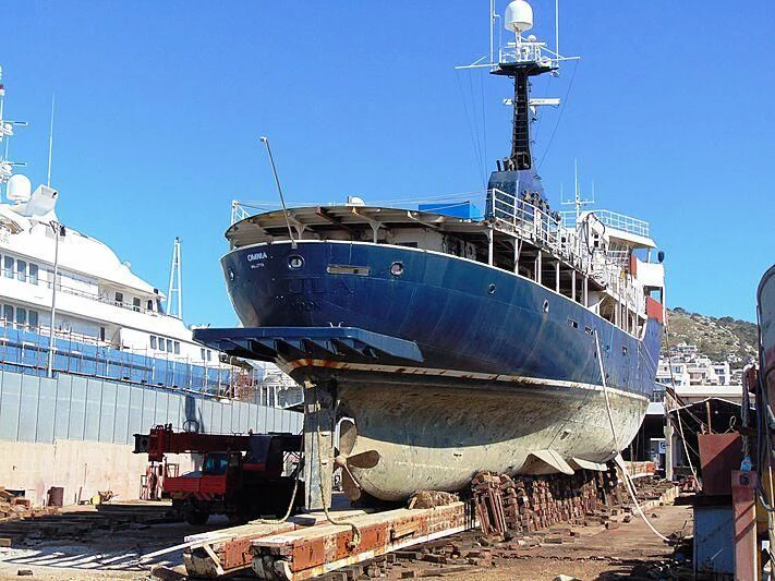 a large ship docked aboard OMNIA Yacht for Sale