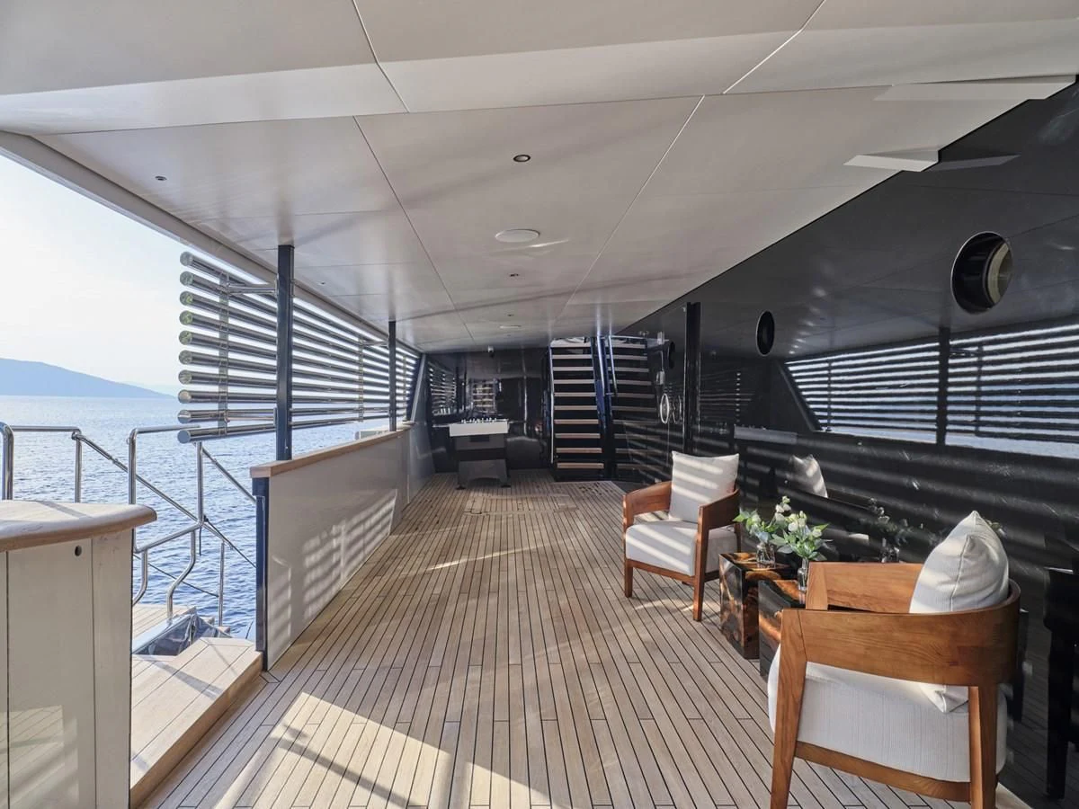 a room with a balcony and a view of the ocean aboard OMNIA Yacht for Sale