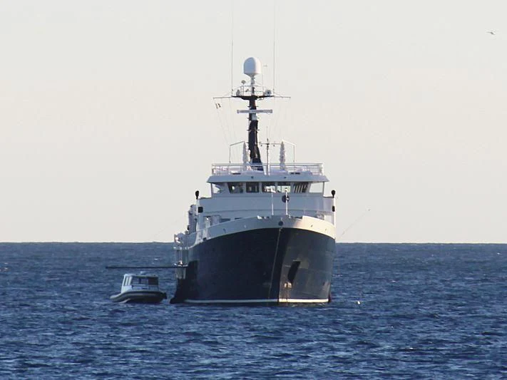 a large ship in the water aboard OMNIA Yacht for Sale