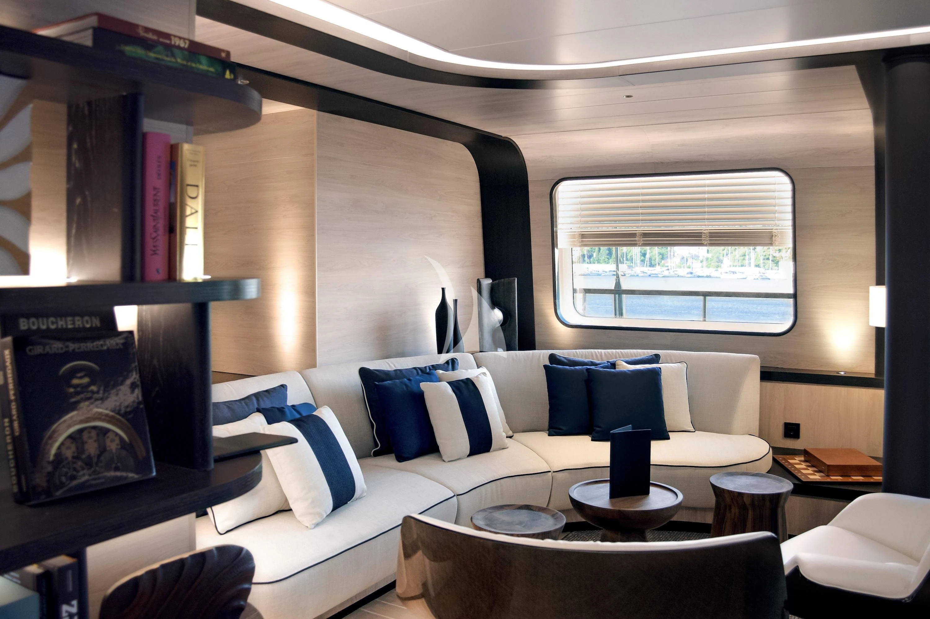 a room with a couch and a table with a lamp on it aboard LE PONANT Yacht for Charter