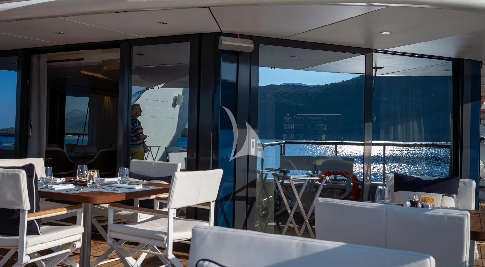 a person standing on a balcony overlooking a city aboard LE PONANT Yacht for Charter