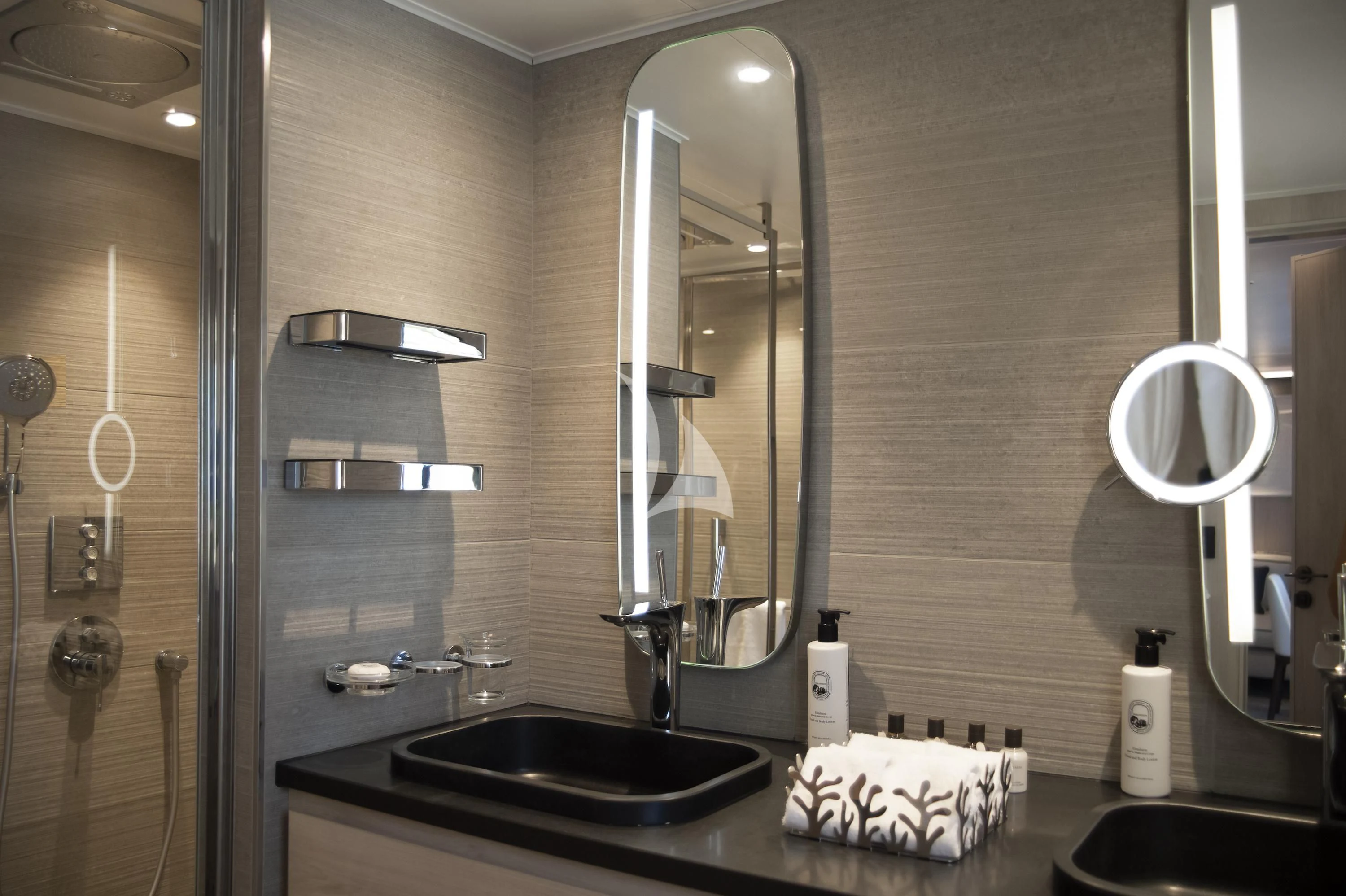 a bathroom with a sink and mirrors aboard LE PONANT Yacht for Charter