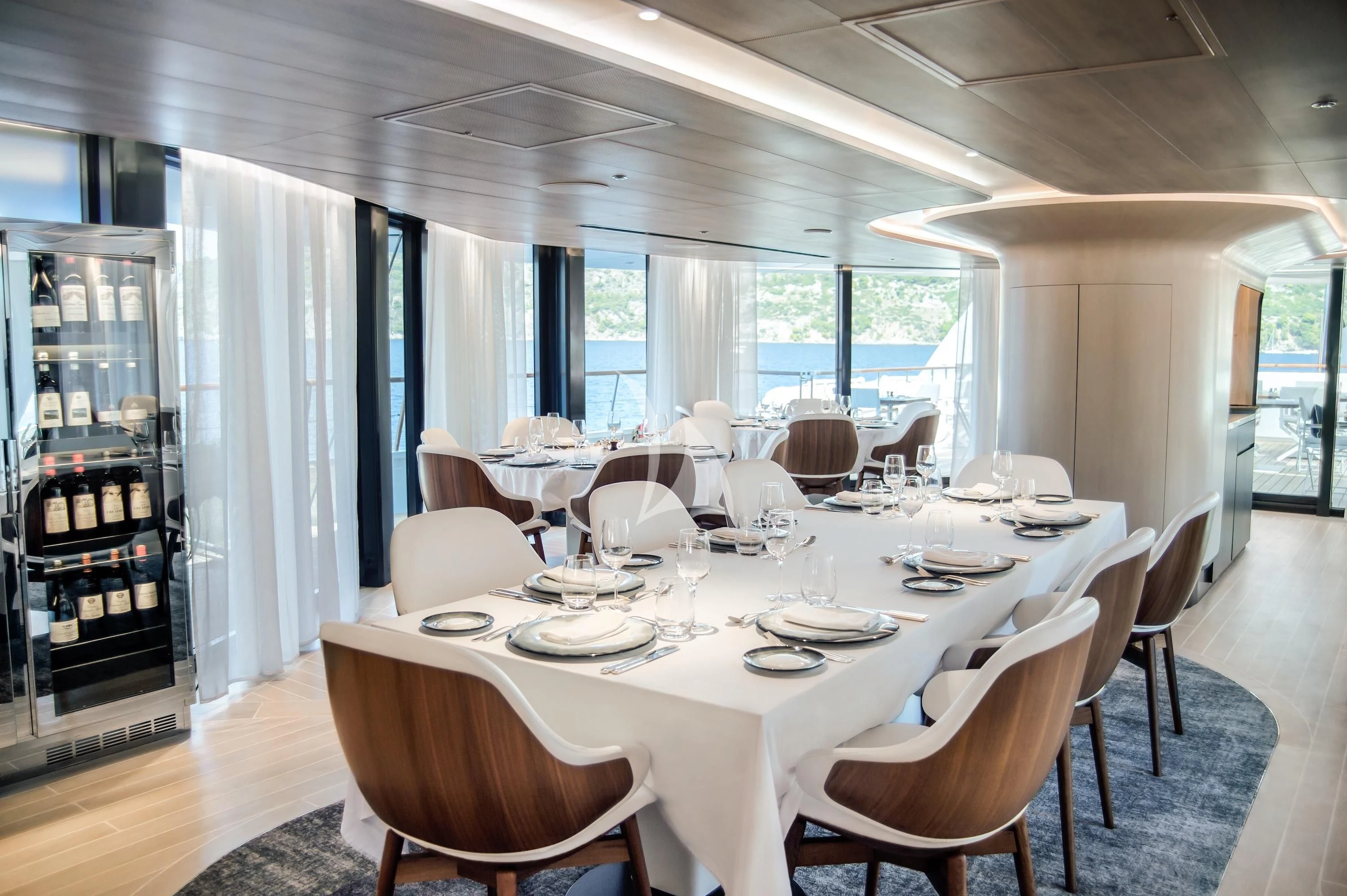 a dining room with a table set aboard LE PONANT Yacht for Charter
