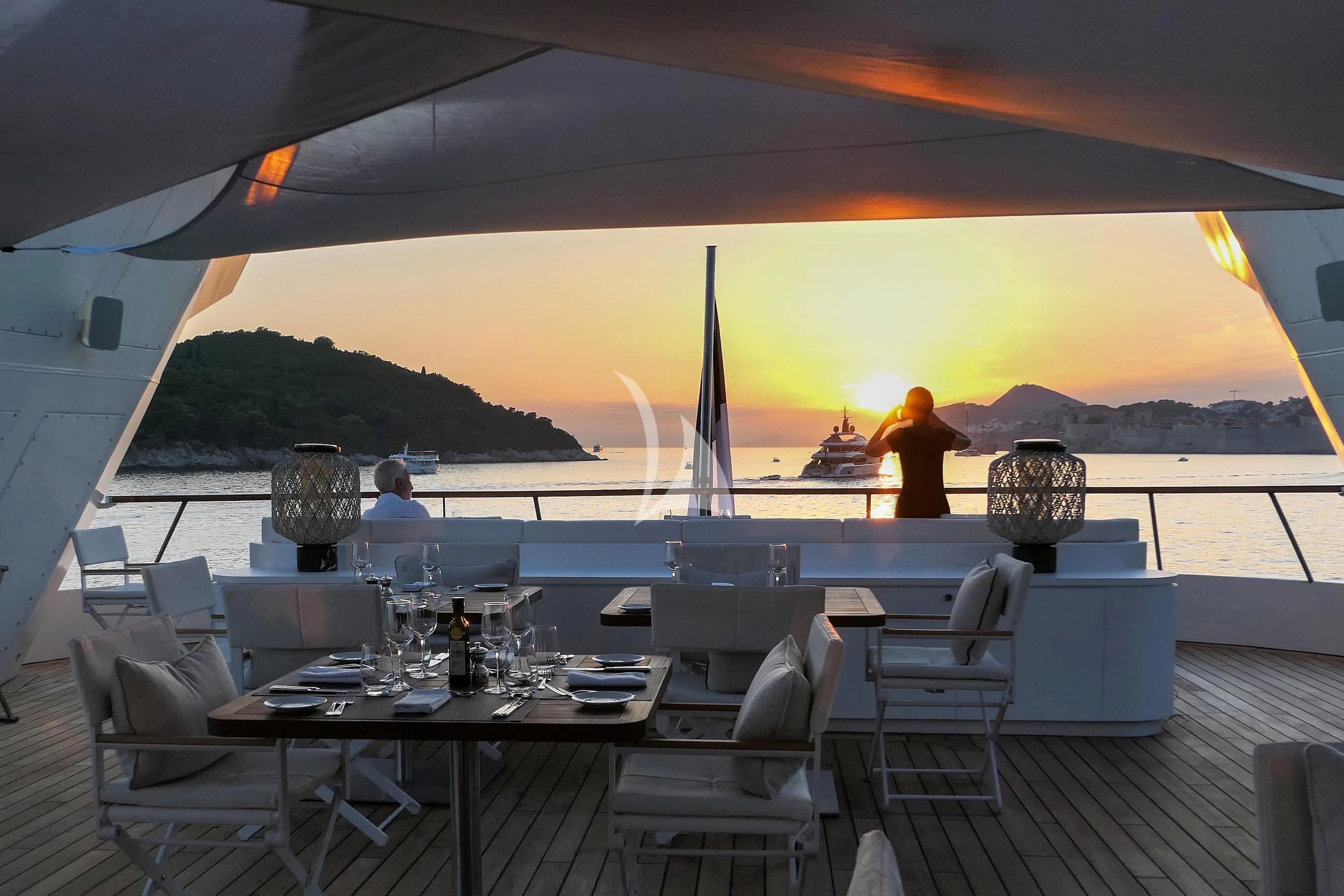 a large patio with tables and chairs aboard LE PONANT Yacht for Charter
