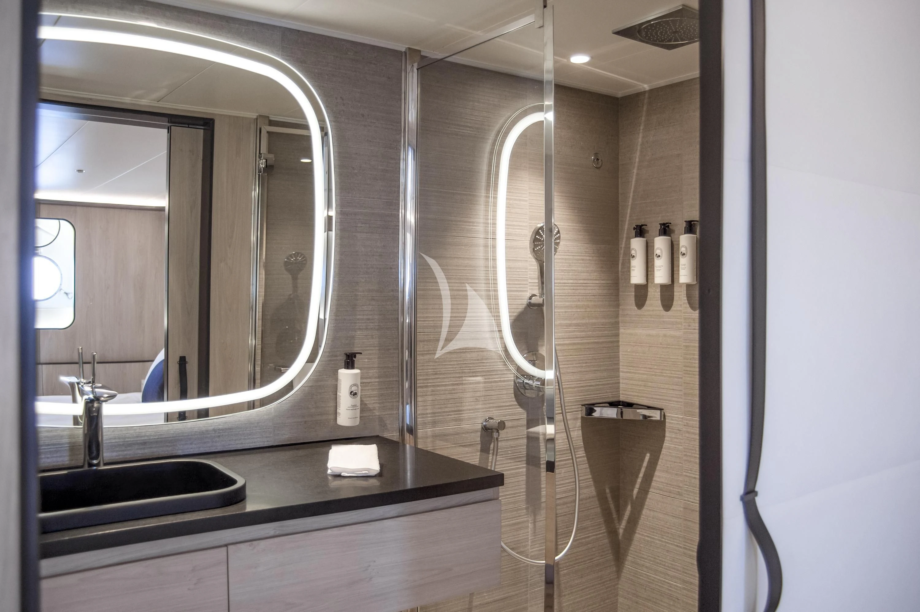 a bathroom with a shower unit and sink aboard LE PONANT Yacht for Charter
