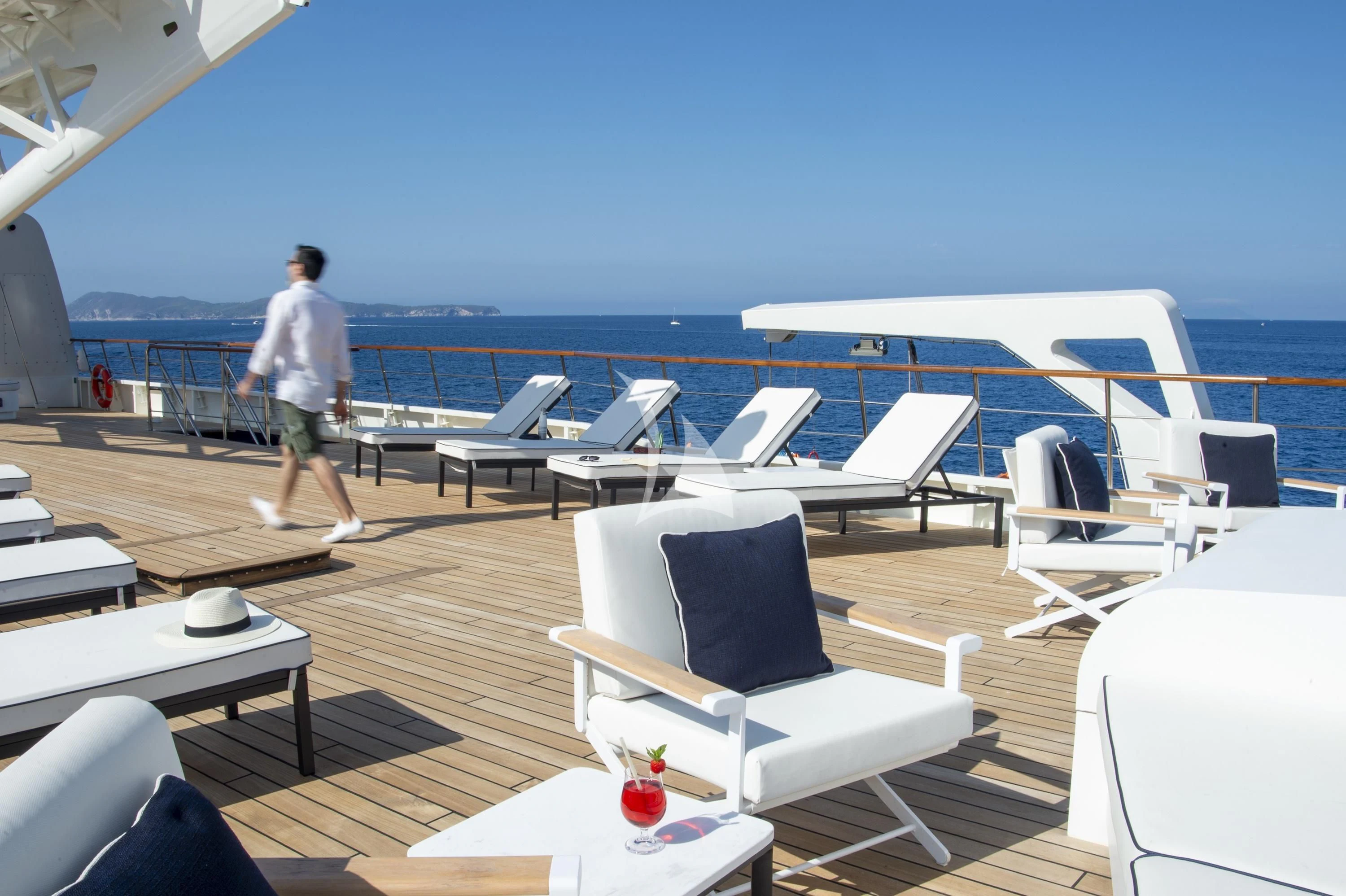 a person walking on a deck of a ship aboard LE PONANT Yacht for Charter