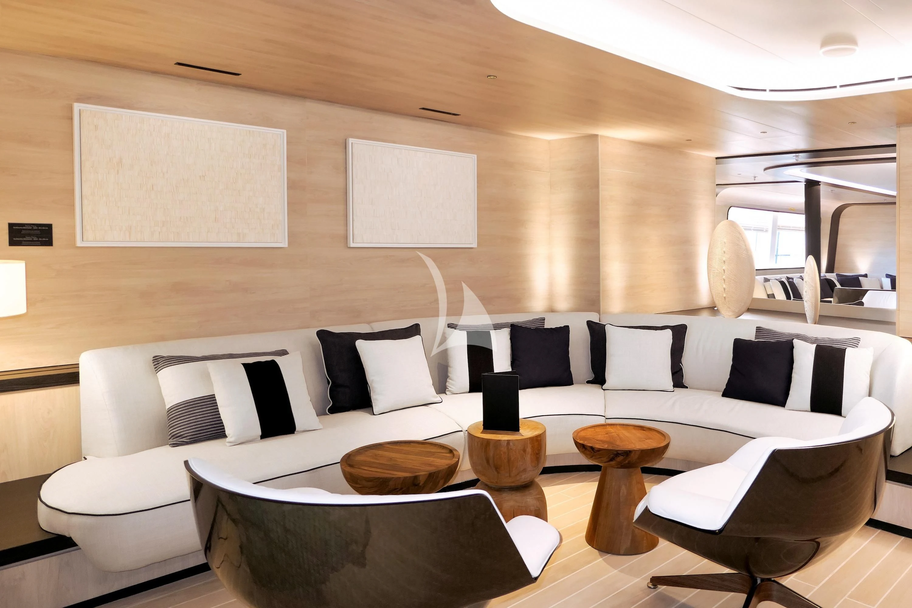 a modern living room with white couches and a large white table aboard LE PONANT Yacht for Charter