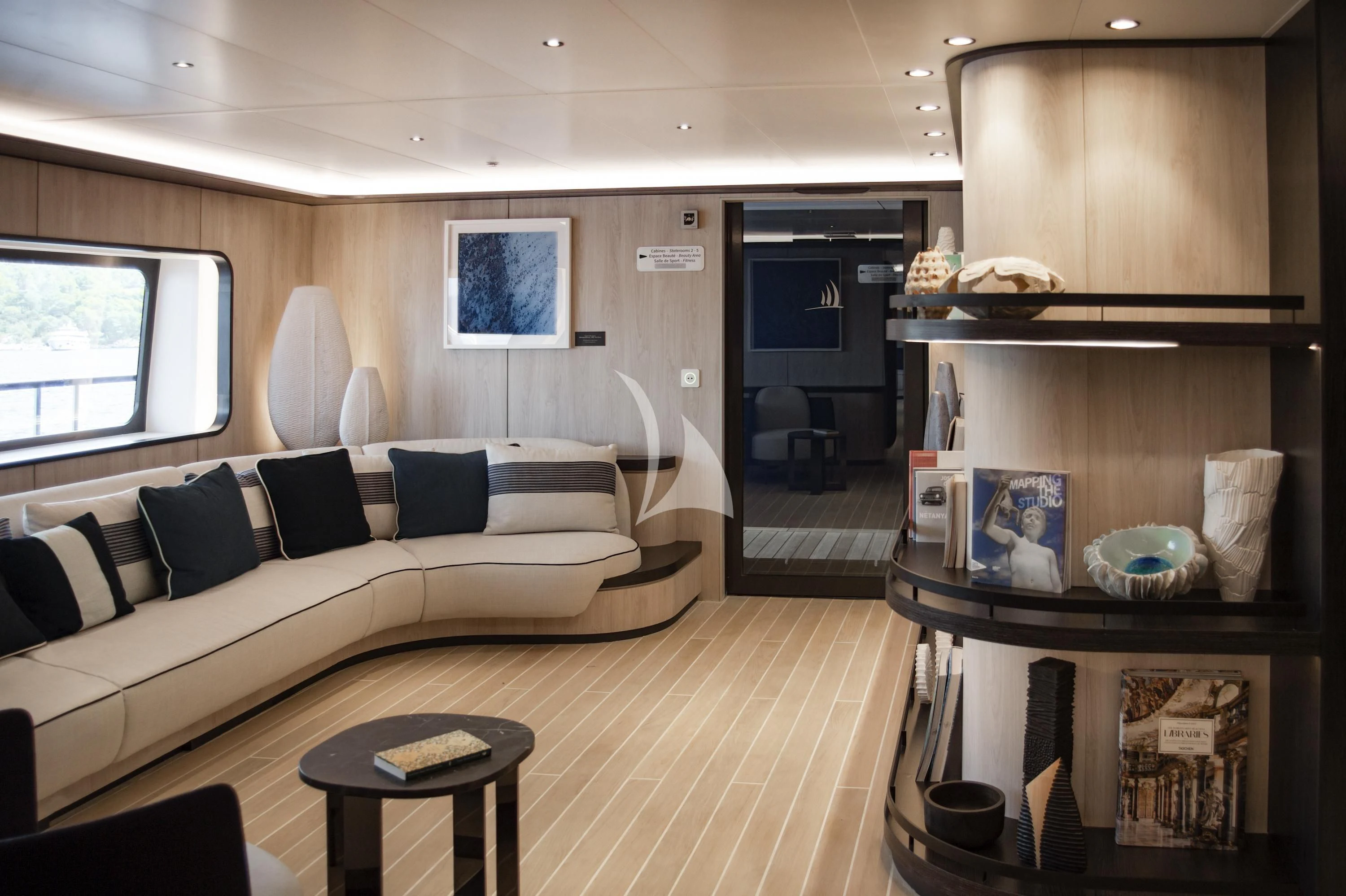 a living room with a couch and a fireplace aboard LE PONANT Yacht for Charter