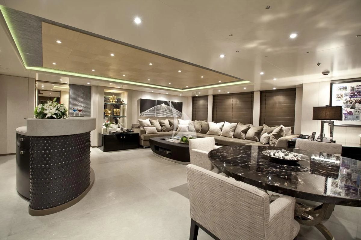 a living room with a large black chair and a large black coffee table aboard HURRICANE RUN Yacht for Charter