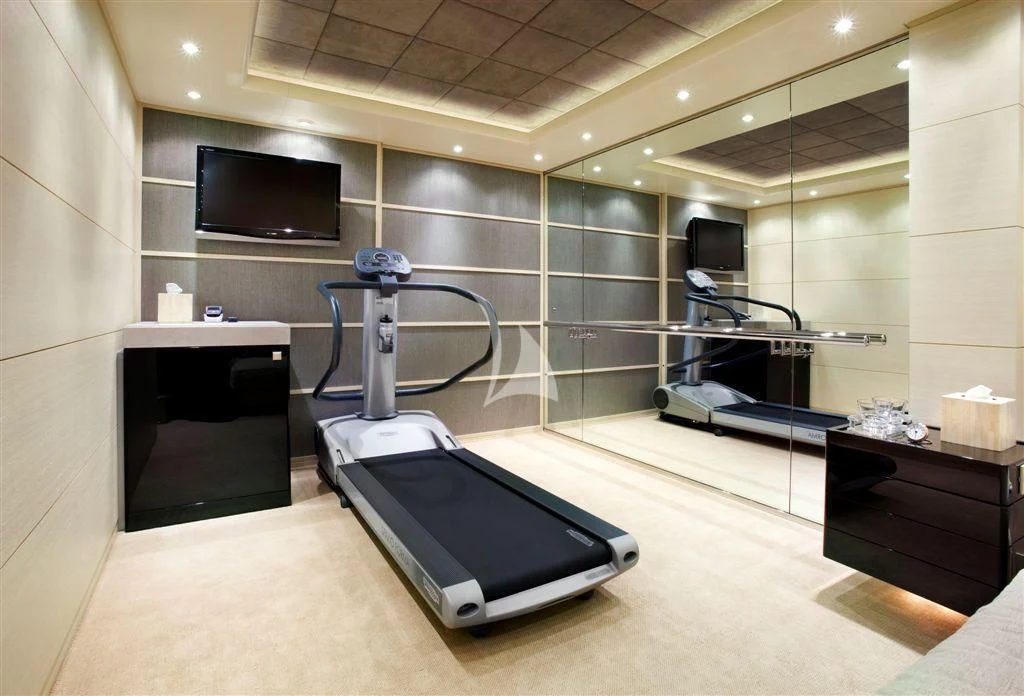 a room with a tv and a table aboard HURRICANE RUN Yacht for Charter