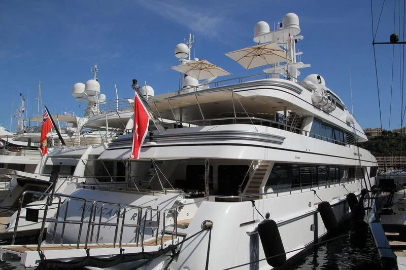 a large white boat with flags aboard HURRICANE RUN Yacht for Charter
