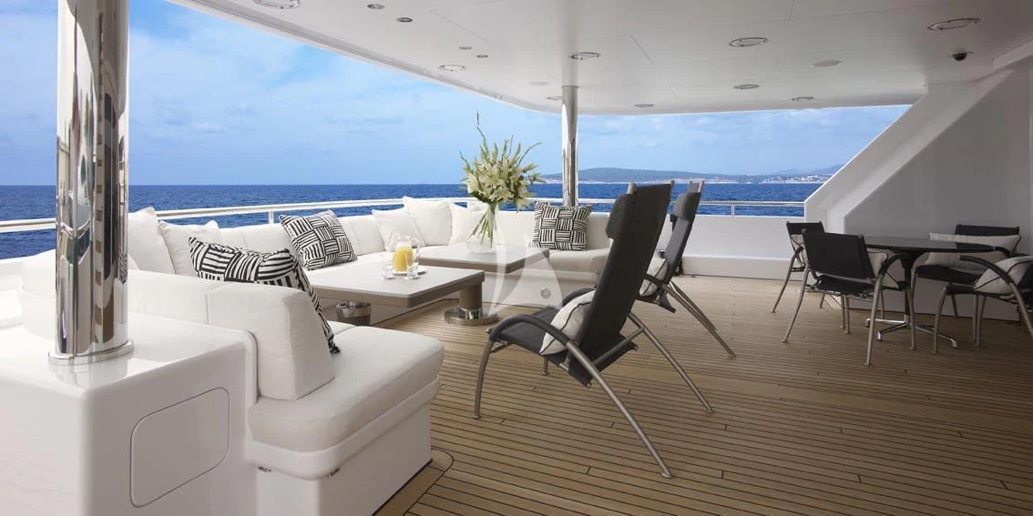 a room with a table chairs and a window aboard HURRICANE RUN Yacht for Charter