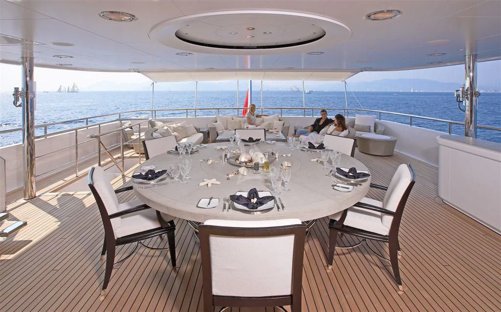 a table set for a meal on a deck overlooking the ocean aboard HURRICANE RUN Yacht for Charter