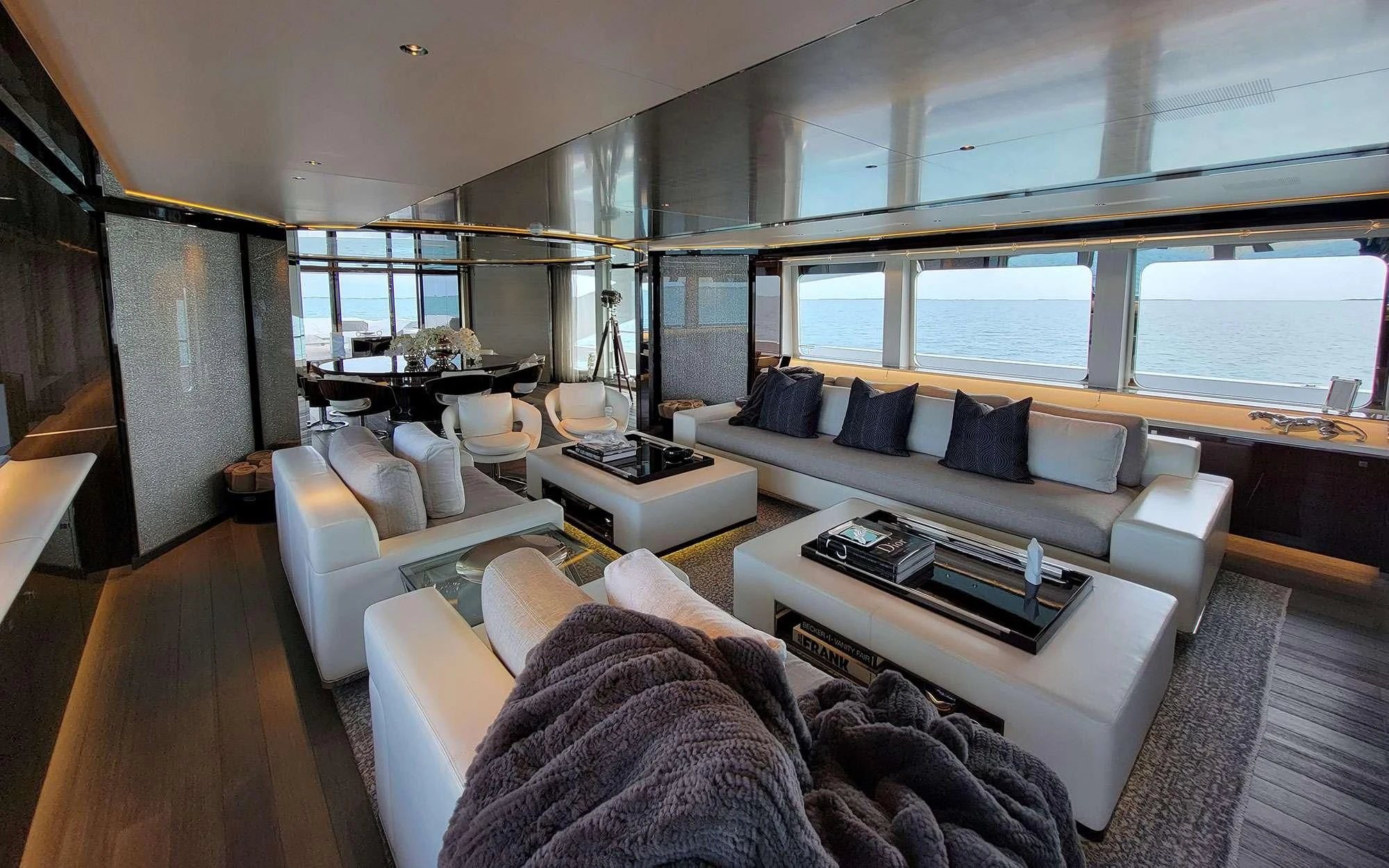 a living room with a large window aboard KNIGHT Yacht for Charter