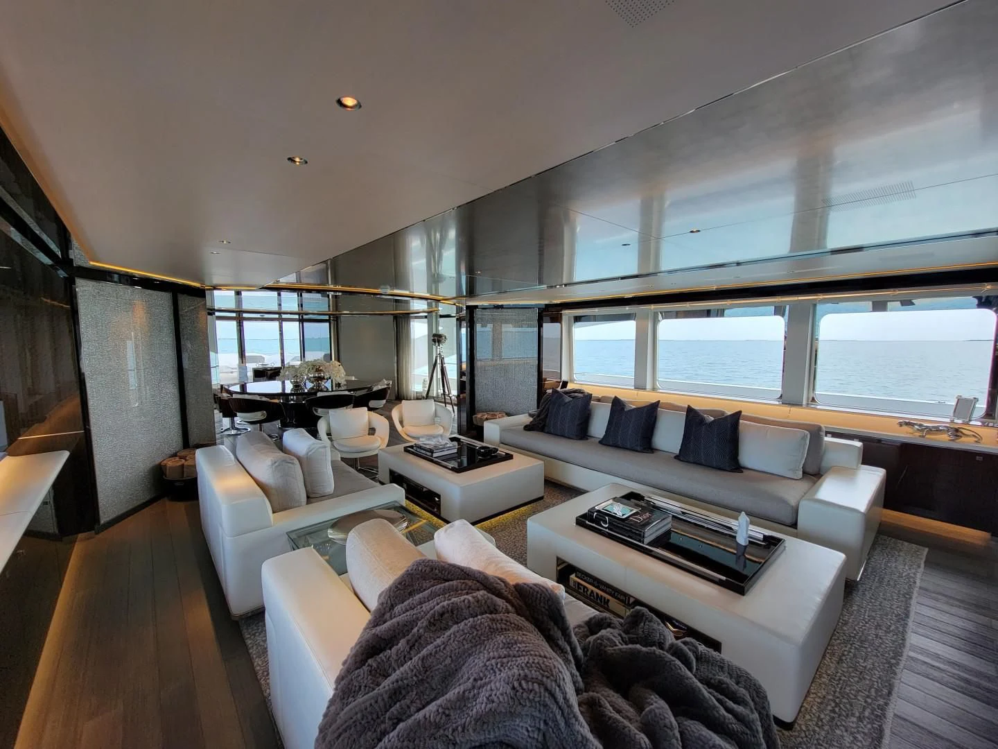 a room with a couch and a table and a large window aboard KNIGHT Yacht for Charter