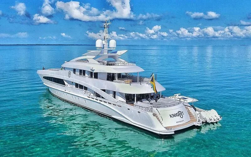 a large white boat in the water aboard KNIGHT Yacht for Charter