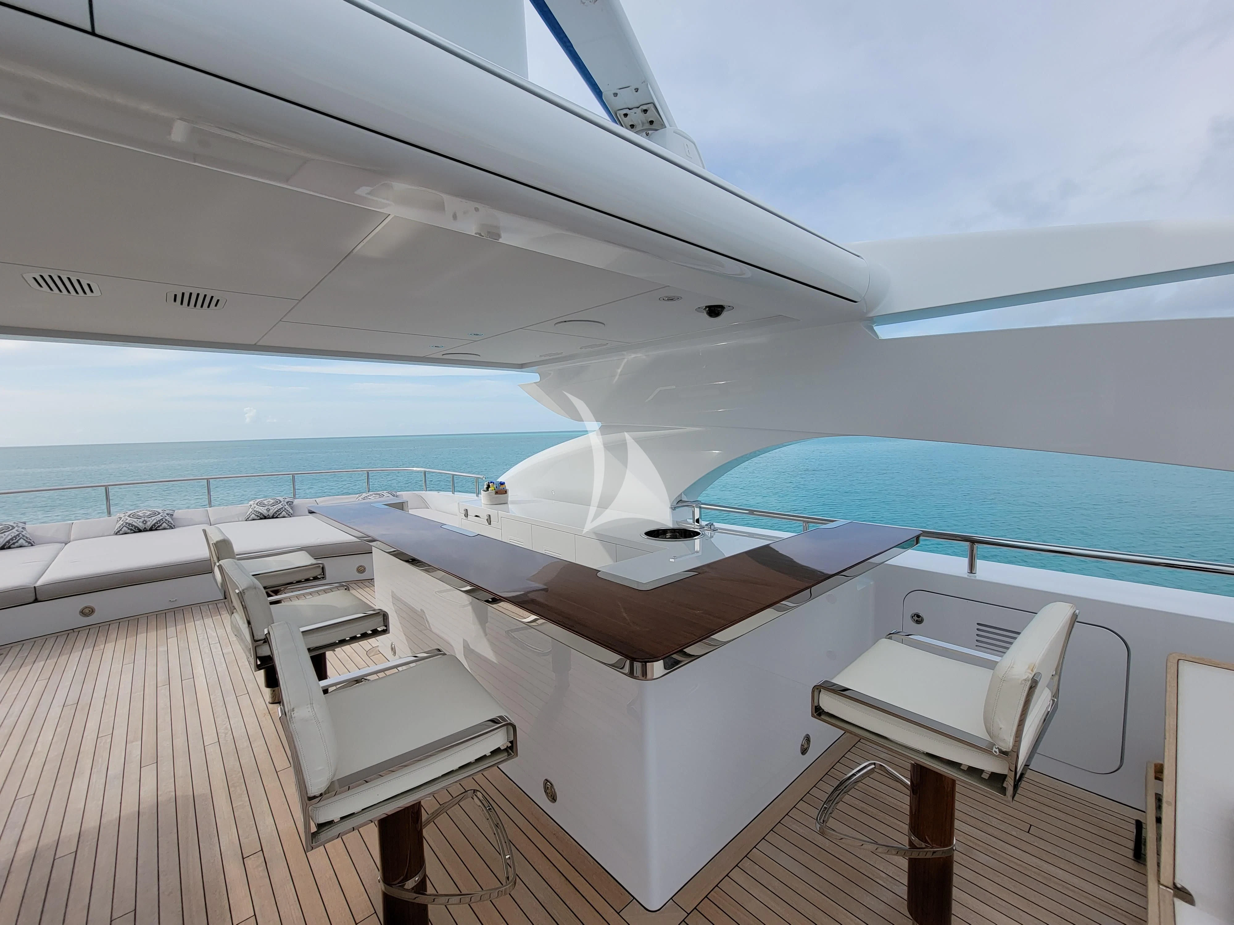a deck with a deck and a view of the ocean aboard KNIGHT Yacht for Charter
