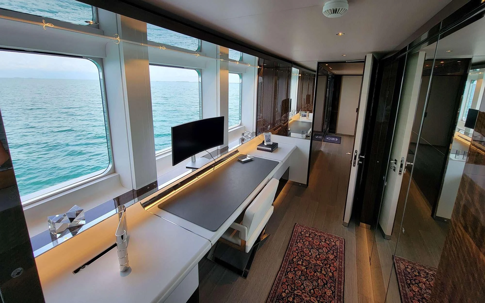 a room with a desk and a tv aboard KNIGHT Yacht for Charter