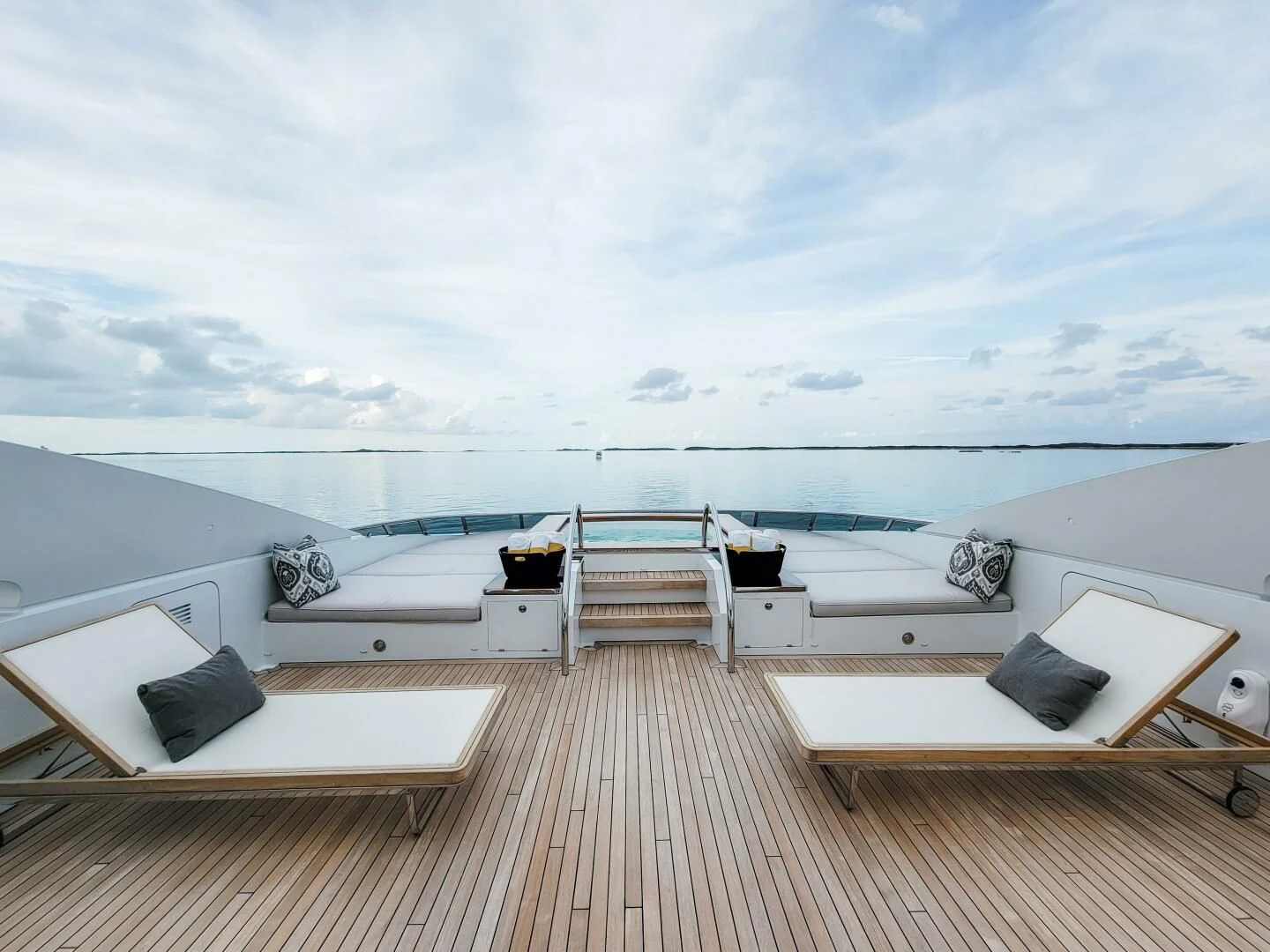 a deck with a view of the ocean and the deck aboard KNIGHT Yacht for Charter
