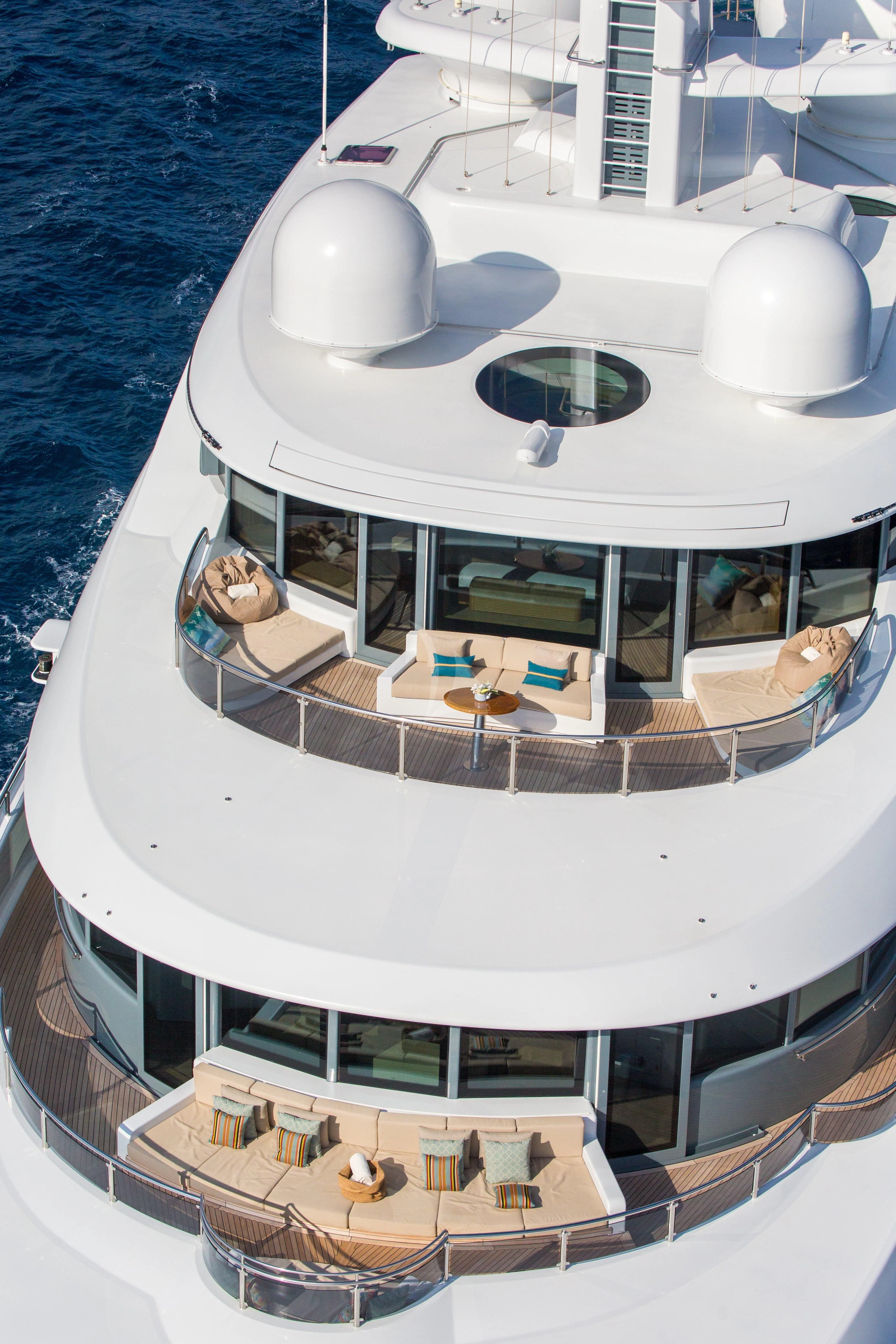 a white boat with a white deck and a white building with a white roof and a blue sky aboard NAIA Yacht for Sale